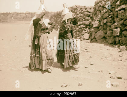 Jebel el-Druze & Hauran. Ghureye. Two Druze women with water cans & fine costumes. 1938, Syria Stock Photo