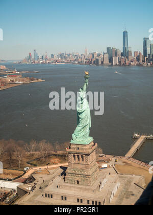 The Statue of Liberty with Manhattan in background seen from an helicopter ride over New York Bay Stock Photo