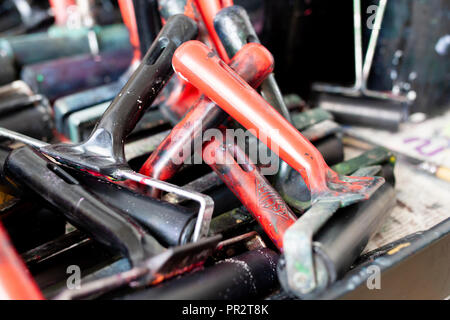 Well used brayers or print rollers used for lino prints and other printing projects.  Used for smooth application of block printing ink and paint. Stock Photo