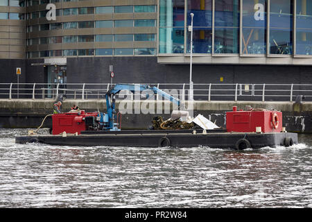 RUBBISH COLLECTION boat at MediaCityUK on the Manchester Ship Canal, inside a basin Salford Quays Stock Photo