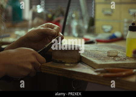 Jewelry designer making jewelry in workshop Stock Photo
