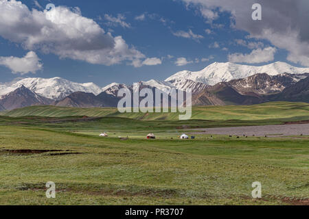 Beautifully located in the Alay Valley between the Zaalay Mountains and the Pamir, the Pamir Highway descends into Kyrgyzstan. Stock Photo