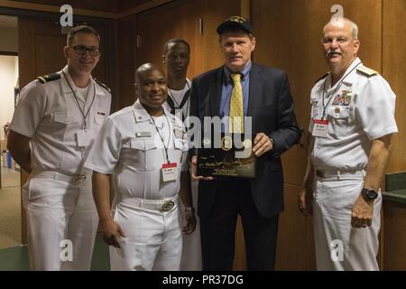 GREEN BAY, Wis. (July 28, 2017) – Rear Adm. Bruce L. Gillingham, Deputy Chief, Bureau of Medicine and Surgery, Readiness & Health, joins Sailors attached to USS Green Bay (LPD 20) in presenting their ship’s ball cap and a plaque to Mark Murphy, president and chief executive officer of the Green bay Packers of the National Football League, during Green Bay/Fox Cities Navy Week. Navy Week programs serve as the U.S. Navy's principal outreach effort into areas of the country that lack a significant Navy presence, helping Americans understand that their Navy is deployed around the world, around the Stock Photo