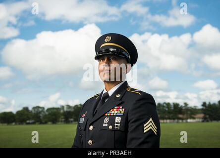 Sgt. Andrew Paredes, a U.S. Army Reserve wheeled vehicle mechanic Soldier with the 841st Engineer Battalion, of North Miami Beach, Florida, participates in a promotional photo shoot for Army Reserve recruiting at Joint Base McGuire-Dix-Lakehurst, New Jersey, July 25, 2017. Stock Photo