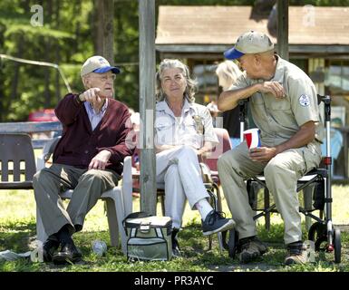 First Sgt. David Brown, Air Force Reserve, talks with Al Tucker Jr., 96, and his daughter, Sue Tucker Brander, after Tucker piloted Brown's PT-17 Stearman biplane to the Flying Circus Aerodrome and Airshow in Bealeton, Va., Jul. 30, 2017. Brander urged her father to come to the Flying Circus, where she works, and introduced him to Brown, who has been letting Tucker fly his Stearman biplane for nearly 10 years. Stock Photo