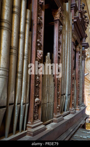 EVORA, PORTUGAL - JULY 01, 2016:  The close view of organ pipes in  baroque case richly decorated with carved work in the Cathedral of Evora. Evora. P Stock Photo