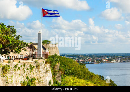 La Cabana Spanish fortress walls and Cuban flag in the foreground, with sea in the background, Havana, Cuba Stock Photo