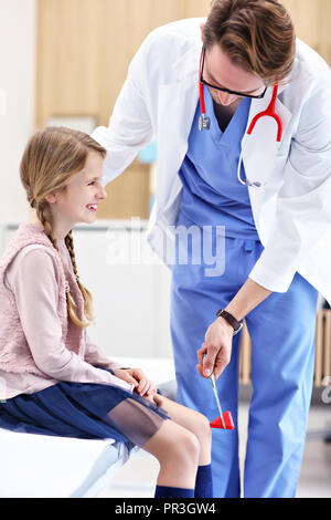 Little girl in clinic having a checkup with neurologist Stock Photo