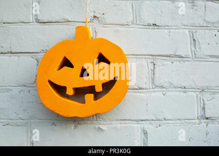 Halloween pumpkin on the white-coloured wall Stock Photo