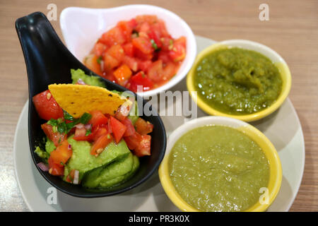 Guacamole and Various Salsa Sauce, Colorful Spicy Mexican Sauce on Wooden Table Stock Photo