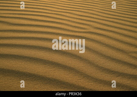 Beautiful abstract pattern of desert sand ripples in the evening sunlight at Huacachina sand dune in Peru Stock Photo