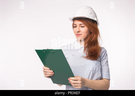 Architect, worker and realtor concept - woman builder or engineer with documents on white background Stock Photo