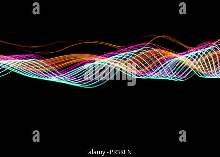 Long exposure light painting photography, curvy lines of vibrant neon pink , green parallel lines and metallic yellow gold against a black background Stock Photo