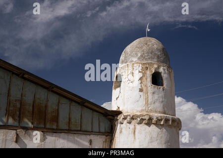 The beautiful minaret of the mosque in the remote village of Karakul on the far-eastern section of the Pamir Highway in Tajikistan. Stock Photo