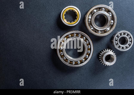 Ball bearing lying on a black background, flat view from above. Stock Photo