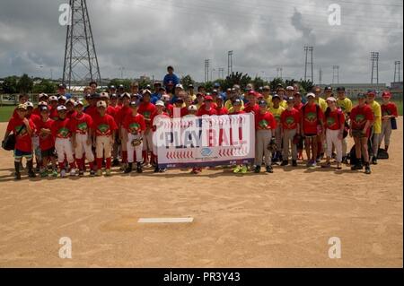 camp foster okinawa japan the afternoon youth baseball clinic participants pose for a group photo july 29 aboard camp foster okinawa japan the baseball clinic hosted four different stations hitting running catching and throwing and a grounders infield fly station once they completed the various stations the participants competed to see who would win for the three stations running hitting and throwing to a target approximately 200 children from elementary school to high school ages participated pr3y43