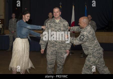 An Airman receives their certificate of promotion at Misawa Air Base