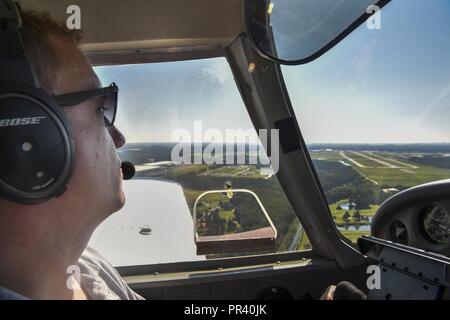 Maj. Ron Johnson, 14th Airlift Squadron C-17 Globemaster III pilot, circles the airport before landing in Savannah, Ga., July 22, 2017. Johnson uses his personal plane to fly dogs from across the country to foster families and non-kill shelters for the Pilots N’ Paws program. Stock Photo