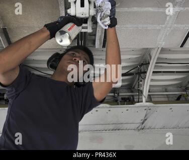 ANDERSEN AIR FORCE BASE, Guam (July 28, 2017) An Aircrewman conducts maintenance on a P3-C Orion Maritime Patrol aircraft attached to Japan Maritime Self-Defense Force’s Air Patrol Squadron (VP) 52 in preparation for Exercise GUAMEX 2017. GUAMEX is a multinational anti-submarine warfare exercise conducted in the waters surrounding Guam, July 31 - Aug. 12. Participants include aircraft and subsurface assets from the Japanese Maritime Self-Defense Force, the Royal New Zealand Air Force, and the United States Navy. Stock Photo