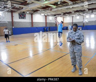 U.S. Air Force Staff Sgt. Kartae Bruce, non-commissioned officer in charge of force health management assigned to the Public Health Element of the 379th Expeditionary Medical Group, takes notes during an inspection of the gym at Al Udeid, Air Base, Qatar, July 26, 2017. The members of the 379th EMDG/SGOL work behind the scenes to help keep Airmen deployed here healthy by inspecting public facilities, ensuring the medical readiness of forward deploying Airmen and by tracking and working to prevent the spread of communicable diseases. Stock Photo