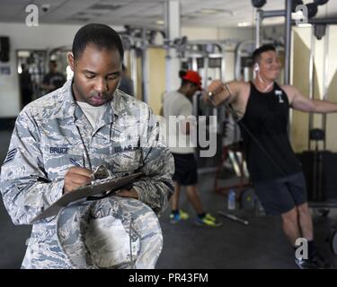 U.S. Air Force Staff Sgt. Kartae Bruce, non-commissioned officer in charge of force health management assigned to the Public Health Element of the 379th Expeditionary Medical Group, conducts an inspection of the gym at Al Udeid, Air Base, Qatar, July 26, 2017. The members of the 379th EMDG/SGOL work behind the scenes to help keep Airmen deployed here healthy by inspecting public facilities, ensuring the medical readiness of forward deploying Airmen and by tracking and working to prevent the spread of communicable diseases. Stock Photo