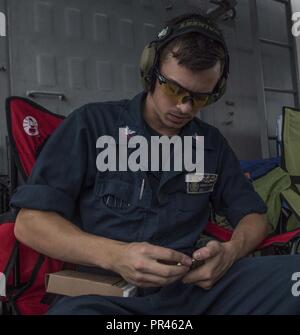 ATLANTIC OCEAN (Sept. 8, 2018) Sonar Technician (Surface) 2nd Class Andrew Jokerst loads 9mm rounds into a magazine guided-missile destroyer USS Forrest Sherman (DDG 98). Forrest Sherman is currently deployed as part of the Harry S. Truman Carrier Strike Group. Harry S. Truman will continue its deployment by conducting sustainment operations in the Atlantic. Stock Photo