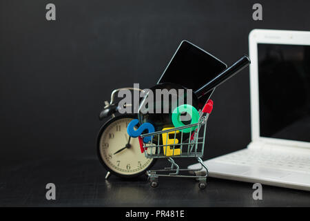SEO Search engine optimization concept Colored letters of SEO with clock, magnifying glass, smartphone, gears in a basket on a black background Copysp Stock Photo