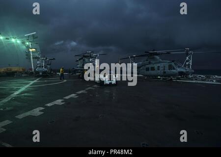 INDIAN OCEAN (Dec. 30, 2017) Sailors conduct flight deck operations on the flight deck of the amphibious transport dock ship USS San Diego (LPD 22). San Diego, part of the America Amphibious Ready Group, with embarked 15th MEU, is operating in the Indo-Asia-Pacificregion to strengthen partnerships and serve as a ready-response force for any type of contingency. Stock Photo