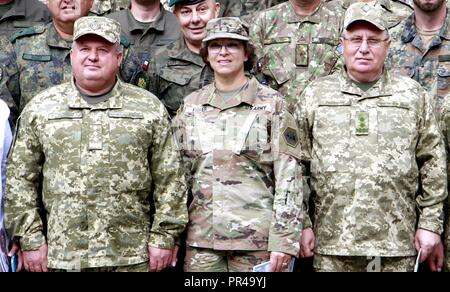 From left: Ukrainian Col. Gen. Serhii Popko, Commander of Ukrainian Land Forces Command, U.S. Army Brig. Gen. Kelly Fisher, California Army National Guard Land Component Commander, Ukrainian Gen. Lt. Pavlo Petrovich Tkachuk, Chief of the Hetman Petro Sahaidachnyi National Army Academy pose for a photo Sept. 7 at the International Peacekeeping Security Centre near Yavoriv, Ukraine. Stock Photo