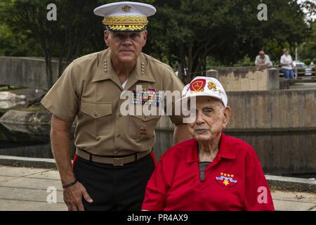 Commandant of the Marine Corps Gen. Robert B. Neller poses for a picture with Iwo Jima veteran, Sgt. Mack Drake (Retired),  21st Marine Regiment, 3rd Marine Division, at the 9/11 Memorial Ceremony, during Marine Week, Charlotte, N.C., Sept. 9, 2018. Marine Week Charlotte is an opportunity to showcase the Corps' capabilities and mission as America’s expeditionary force in readiness. Stock Photo