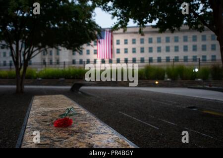 A large American flag is unfurled over the west side of the Pentagon at sunrise in Washington, D.C., Sept. 11, 2018. During the Sept. 11, 2001, attacks, 184 people were killed at the Pentagon. Stock Photo