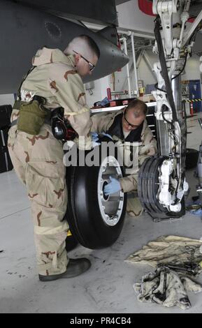 Oregon Air National Guard Airmen assigned to the 142nd Fighter Wing work on the brakes of an F-15C Eagle at the Portland Air National Guard Base, Oregon, during a combat readiness training exercise, Sept. 8, 2018. Stock Photo