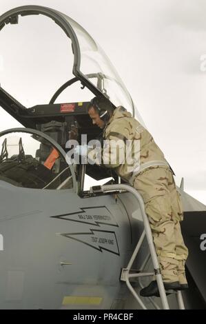 A F-15C Eagle assigned to the 142nd Fighter Wing, Portland Air National Guard Base, Oregon, is inspected by an maintainer during a combat readiness training exercise, Sept. 8, 2018. Stock Photo