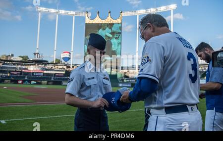 Airman 1st Class Jonathan Costanza, 509th Maintenance Squadron metals technician, exchanges an Air Force cap for a Kansas City Royals baseball cap from Ned Yost, the current manager of the Royals baseball team, at Kauffman Stadium, Sept. 11, 2018, in Kansas City, Mo. The KC Royals recognized service members, wounded veterans and victims of the 9/11 terror attacks during the Kansas City Royals Armed Forces Night. Stock Photo