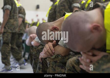 U.S. Marine Corps recruits with Fox company, 2nd Battalion, Recruit Training Regiment, wait during the “Moment of Truth” event on Marine Corps Recruit Depot Parris Depot, S.C., Sept. 12, 2018. Operations have returned to normal aboard the base following the termination of the evacuation order that the base had been under Stock Photo