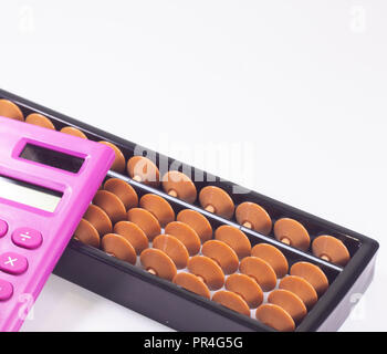 Abacus and pink calculator on white background Stock Photo