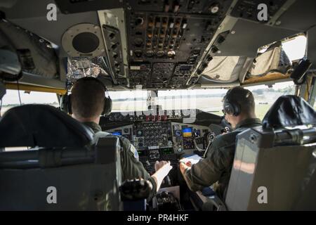 U.S. Air Force Capt. Jesse Prater, left, and Maj. Micah Yost, 351st Air Refueling Squadron pilots, taxi a KC-135 Stratotanker before take-off at RAF Mildenhall, England, Sept. 13, 2018. The 100th ARW supported training with a U.S. Air Force B-52 and Romanian Air Force F-16s in the airspace above Romania. Stock Photo