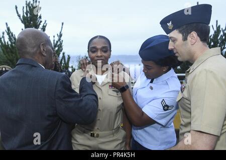 Wash. (Sept. 14, 2018) - Chief Personnel Specialist Stacy Gleason, a native of North Hollywood, Calif., is pinned to the rank of chief petty officer (CPO) by her parents, husband, and sister during Naval Hospital Bremerton's (NHB) CPO pinning ceremony. During the ceremony, five Sailors from NHB received their anchors. Stock Photo