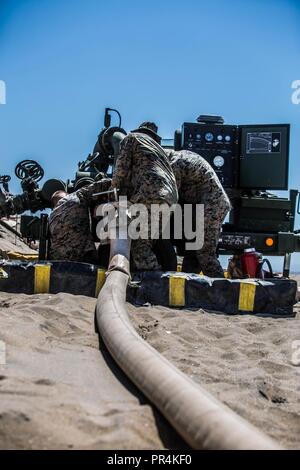 U.S. Marines with Bulk Fuel Company, 7th Engineer Support Battalion, 1st Marine Logistics Group, perform maintenance checks on fuel pumps during an Amphibious Bulk Liquid Transfer System Exercise at Coronado Island, Calif., September 11, 2018. Water and fuel make up the greatest quantities of supply required by the Marine air-ground task force to conduct modern warfare. Stock Photo