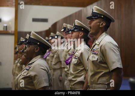 PEARL HARBOR (Sept. 14, 2018) Newly-pinned chief petty officers sing 'Anchors Aweigh' during a chief petty officer pinning ceremony at the Hickam Chapel on Joint Base Pearl Harbor-Hickam, Sept. 14. The ceremony recognized 20 newly-pinned chiefs assigned to the Hawaii region. Stock Photo