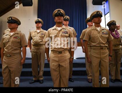 PEARL HARBOR (Sept. 14, 2018) Newly-pinned chief petty officers stand at attention during a chief petty officer pinning ceremony at the Hickam Chapel on Joint Base Pearl Harbor-Hickam, Sept. 14. The ceremony recognized 20 newly-pinned chiefs assigned to the Hawaii region. Stock Photo