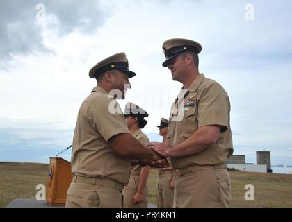 HARBOR, Wash. (Sept. 14, 2018) — Senior Chief Aviation Machinist's Mate Luis Ruiz, attached to Patrol Squadron (VP) 47, congratulates Chief Aircrewman (Operator) Douglas Blynn, attached to VP-47, after being promoted to chief petty officer (CPO) during the Naval Air Station Whidbey Island (NASWI) CPO pinning ceremony. The ceremony marks the first iteration of Sailor 360 and the culmination of a six-week long intense training cycle that has been built off of almost two and a half centuries of naval heritage and 125 years of CPO tradition. VP-47 flies the P-8A Poseidon, the Navy's premiere long- Stock Photo