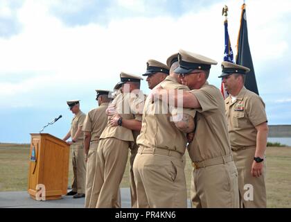 OAK HARBOR, Wash. (Sept. 14, 2018) — Chief Aviation Electronics Technician Kenneth Rodgers, front right, attached to Patrol Squadron (VP) 47, hugs Chief Aviation Structural Mechanic Clint Perez, front left, attached to VP-47, after being promoted to chief petty officer (CPO) during the Naval Air Station Whidbey Island's (NASWI) CPO pinning ceremony. The ceremony marks the first iteration of Sailor 360 and the culmination of a six-week long intense training cycle that has been built off of almost two and a half centuries of naval heritage and 125 years of CPO tradition. VP-47 flies the P-8A Pos Stock Photo