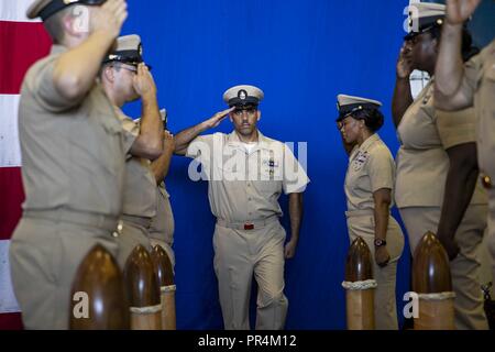 ATLANTIC OCEAN (Sept. 14, 2018) Side boys render honors to Chief Information Systems Technician Daniel Jimenez as he prepares to enter the Chief's Mess during a chief pinning ceremony in the hangar bay of the Wasp-class amphibious assault ship USS Kearsarge (LHD 3). U.S. Naval Forces Northern Command deployed Kearsarge, along with embarked elements of the 22nd Marine Expeditionary Unit and the Expeditionary Strike Group 2 command element, to be positioned to provide Defense Support to Civil Authorities from the sea in response to Hurricane Florence, should support be requested. Stock Photo