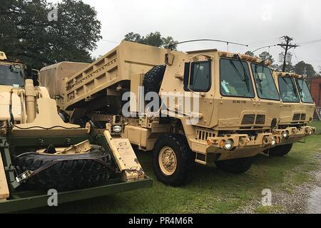 South Carolina National Guard Soldiers from the 1222nd Engineer Company positioned themselves and their engineering equipment at the Conway Armory, Conway, South Carolina, Sept. 15, 2018, to assist in the cleanup and recovery in the aftermath of Hurricane Florence, which was downgraded to a tropical storm Friday evening as it entered South Carolina.  The unit stands ready to assist with debris removal and road clearing as needed to help the citizens of South Carolina in the aftermath of the storm. Stock Photo