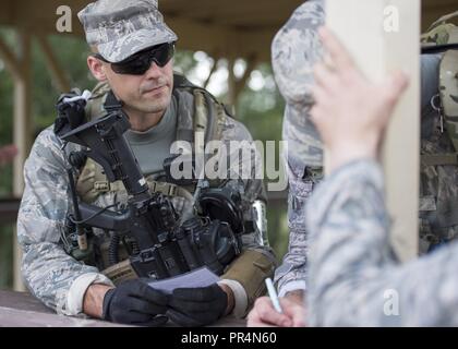 Tech. Sgt. Dedrick Baublitz, a security forces craftsman with the 103rd Security Forces Squadron, Windsor Locks, Connecticut, and Air National Guard Defender’s Challenge team member holds instructions obtained at station one of the dismounted operations component of the Air Force Defender’s Challenge 2018 at Camp Bullis, San Antonio, Texas, on Sept. 12, 2018. This portion of the challenge was designed to stretch and test the skills of the defenders during an extensive loaded march. Stock Photo