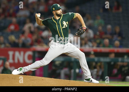 Oakland Athletics relief pitcher Lou Trivino wipes sweat from his forehead  after allowing a walk against the Texas Rangers during the ninth inning of  a baseball game in Oakland, Calif., Friday, July