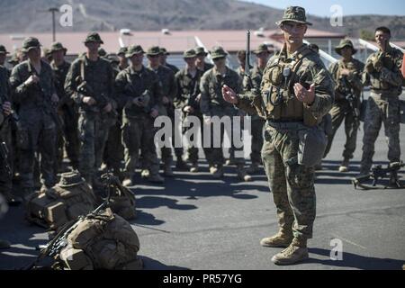 Marine Corps Base Camp Pendleton, CA — Capt. Kyle Padilla, commanding officer, Lima Company, 3rd Battalion, 5th Marine Regiment, speaks to Marines after a hike aboard Camp Pendleton, Calif., Sept. 13, 2018. The Marines completed a three day combined arms exercise consisting of firing small arms, rockets and mortars, culminating with a six mile hike. Stock Photo