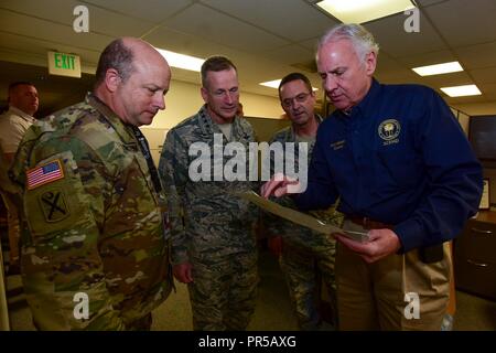 U.S. Army Maj. Gen. Robert E. Livingston Jr., the Adjunct General for South Carolina, left, U.S. Air Force General Terrence J. O’Shaughnessy, the commander of the United States Northern Command and North American Aerospace Defense Command, U.S. Air Force General Joseph Lengyel, the Chief of the National Guard Bureau, and Henry McMaster, the Governor of South Carolina, review a map of areas affected by Tropical Storm Florence, September 18, 2018. More than 3,400 South Carolina National Guard Airmen and Soldiers have been mobilized to prepare, respond and participate in recovery efforts as Tropi Stock Photo