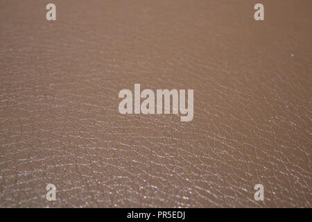 Beige shiny leatherette or imitation leather macro shot for background Stock Photo